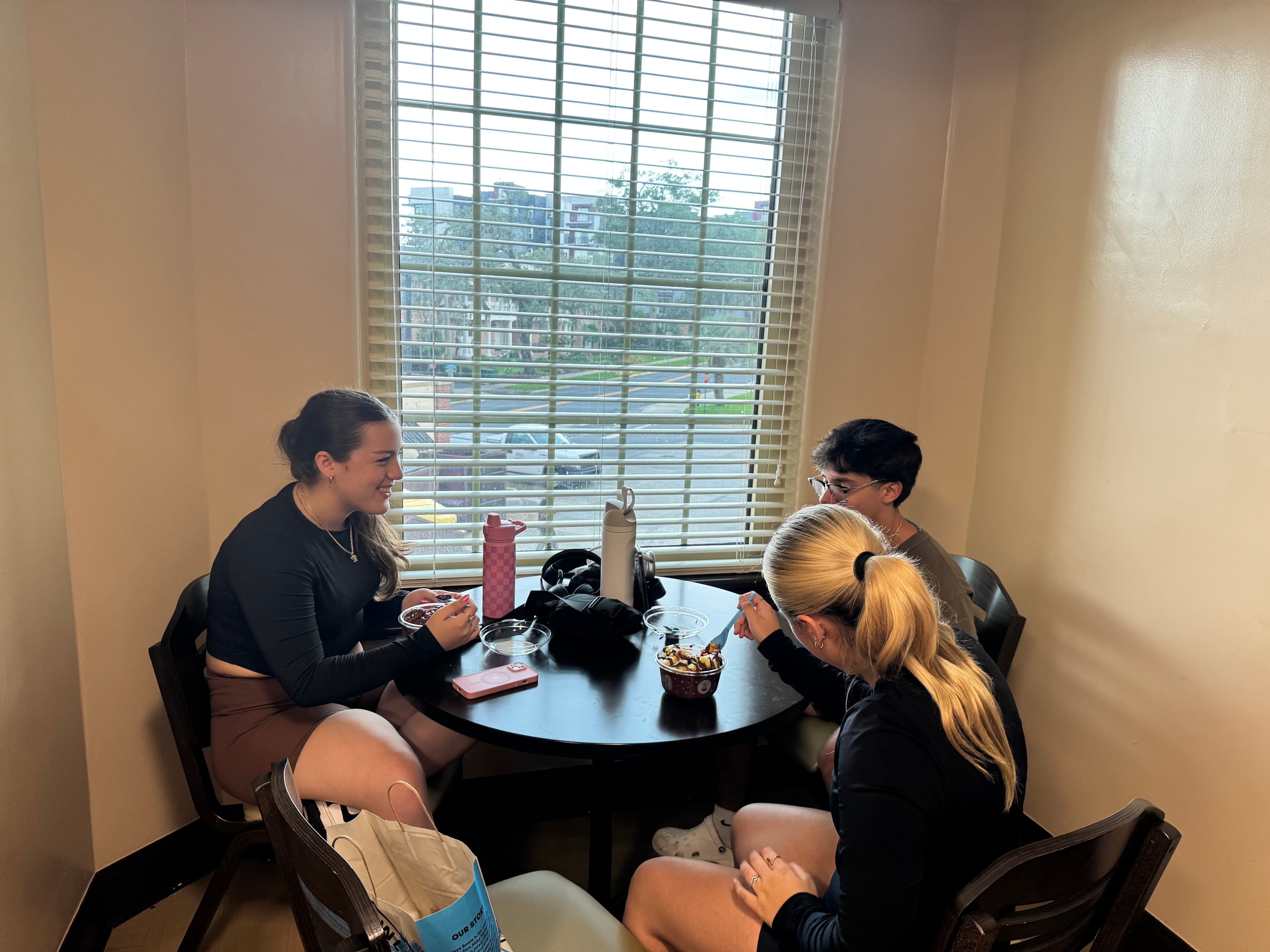 Students sharing food around a table